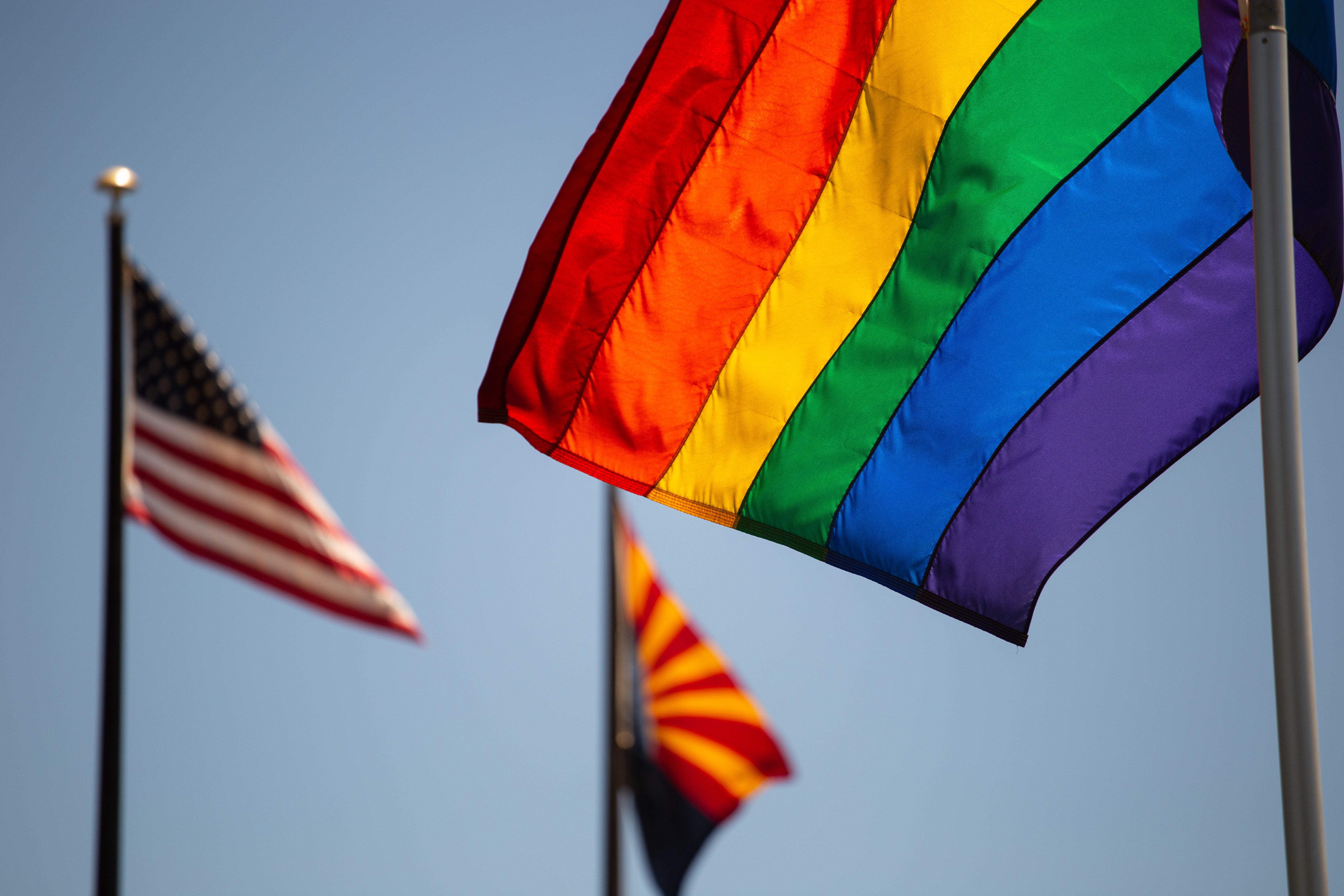 Arizona state flag alongside pride flag