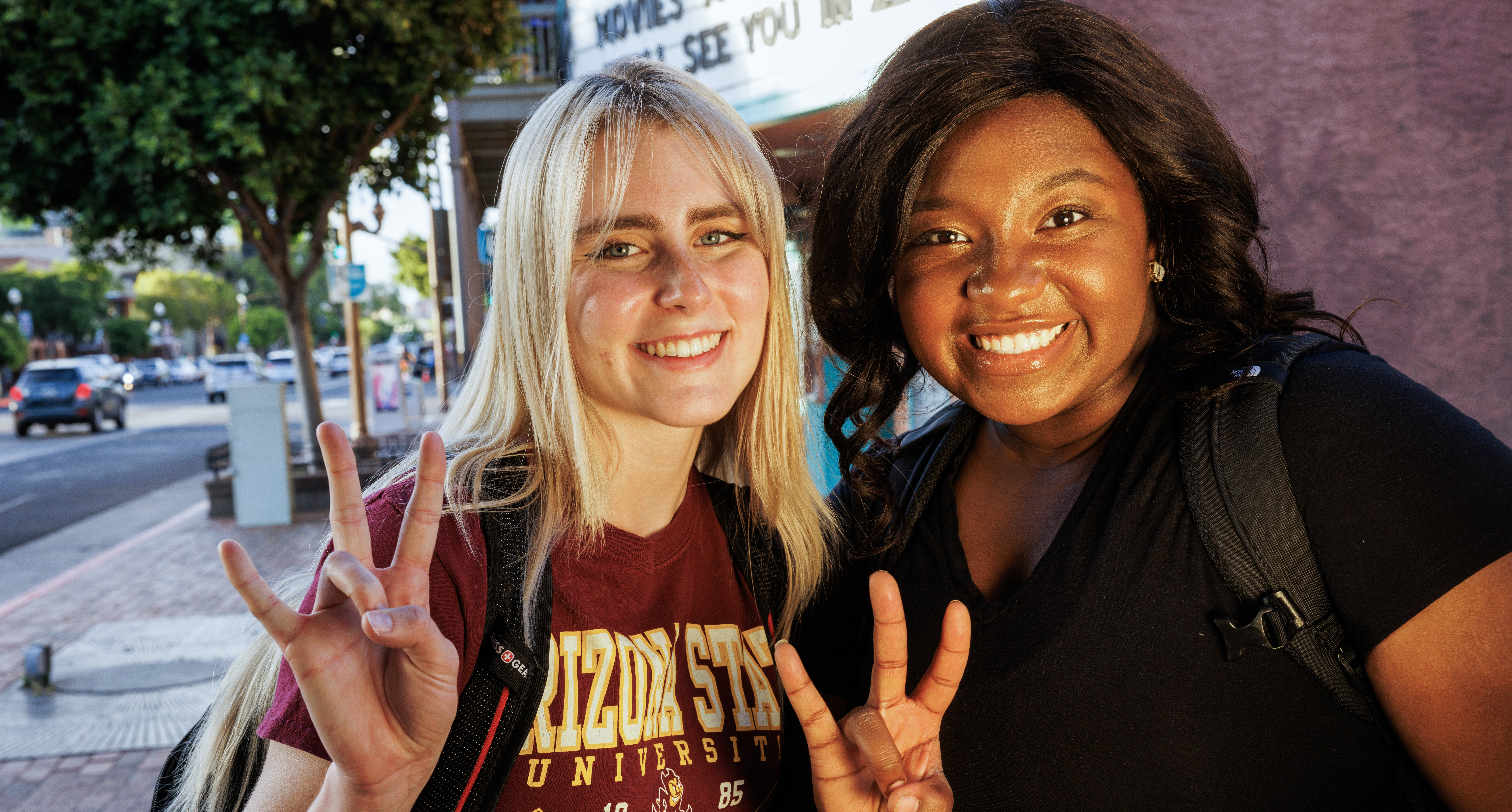 two female students holding up the Forks Up sign